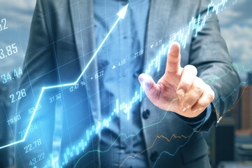 Businessman hand pointing at stock chart screen interface with data.