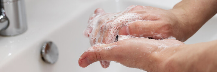 Fototapeta premium Man washing his Hands to prevent virus infection and clean dirty hands