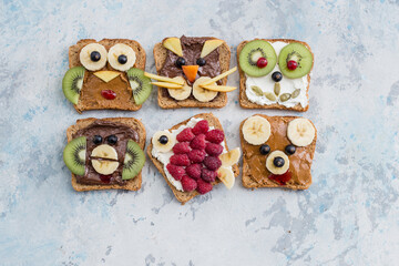 Funny breakfast toast for kids shaped as cute cat, dog, bear, pig, fish. Food art sandwich for child. Isolated. Animal faces toasts with spreads, fruits