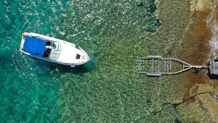 Aerial top view photo of inflatable speed boat on trailer being towed by truck from emerald exotic...