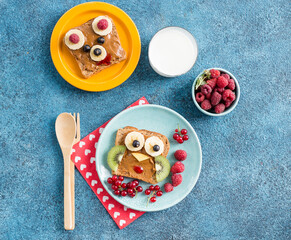 Funny breakfast toast for kids shaped as cute owl, dog. Food art sandwich for child. Isolated. Animal faces toasts with spreads, fruits