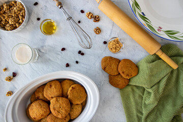 Homemade sugar cookies with nuts, dried fruit and baking utensils