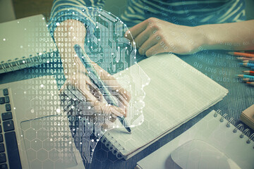 Multi exposure of writing hand on background with brain hologram. Concept of self learning.