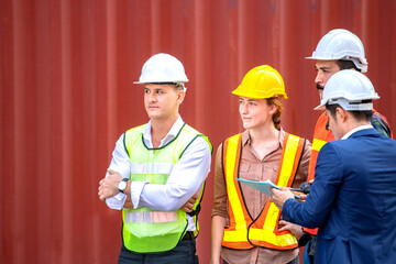 Industrial worker working at cargo freight logistic warehouse for import export, foreman team meeting and brainstorm , Import and export business.