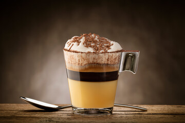 Cup of coffee with milk foam, white chocolate and chocolate chips.