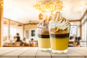 Coffee cream cups on wooden table into coffee shop.