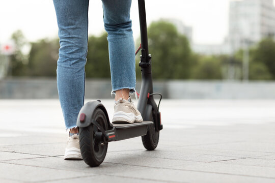 Girl having pleasant ride on electric kick scooter