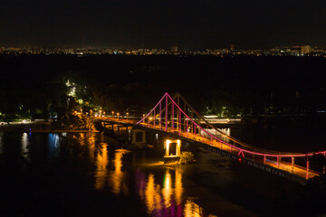 Fototapeta na wymiar Night panorama of pedestrian bridge on Dnipro in Kiev Ukraine