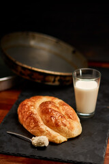 Freshly made pastry burek on black stone cutting board. Very shallow depth of field