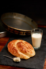 Freshly made pastry burek on black stone cutting board. Very shallow depth of field