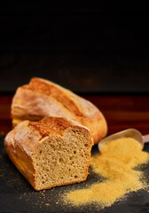 Freshly made white bread on black stone cutting board. Very shallow depth of field