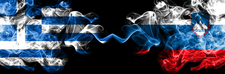 Greece vs Slovenia, Slovenian smoky mystic flags placed side by side. Thick colored silky abstract smoke flags.