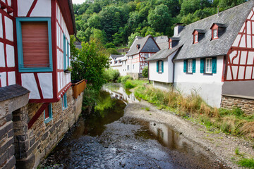 Fototapeta na wymiar Rural scene with half-timbered houses beside a creek in a typical ancient German village
