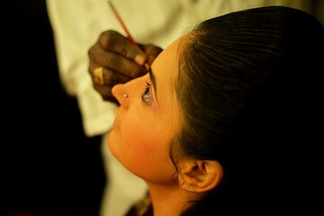 Indian girl touching makeup