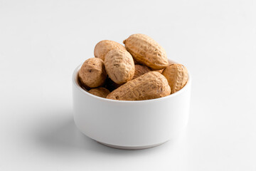 Closeup on isolated peanut nuts in a bowl