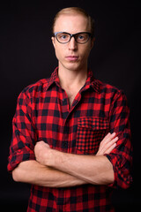 Man with blond hair against black background