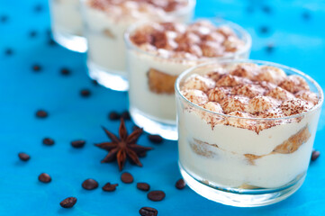 classic Italian dessert tiramisu in glasses, decorated with cocoa powder