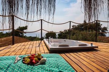 Obraz na płótnie Canvas Hot tub in the room balcony with sea view. Luxury honeymoon romantic vacation place.