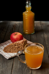 Kvass drink in a glass jar on an old wooden board with rye bread 