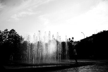 children playing in the fountain black and white photography