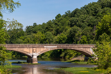 Fototapeta premium A concrete bridge over water in Venango County, Pennsylvania, USA on a sunny summer day