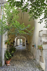 Fototapeta na wymiar A narrow street between the old buildings of Venafro, a medieval village in the Molise region.