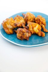 Chicken Wings Spicy chicken wings, breaded, fried, cooked.