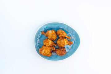 Chicken Wings Spicy chicken wings, breaded, fried, cooked.