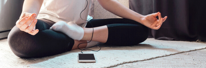 Quarantine,isolation,antidepression.teenage girl practices yoga remotely, relaxes corona...