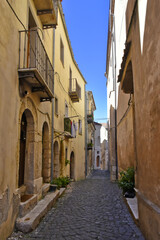 Fototapeta na wymiar A narrow street between the old buildings of Venafro, a medieval village in the Molise region.