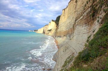 Loggas beach at Peroulades is a paradise beach at high rocky white cliff and crystal clear azure water in Corfu, close to Cape Drastis, Ionian island, Greece, Europe