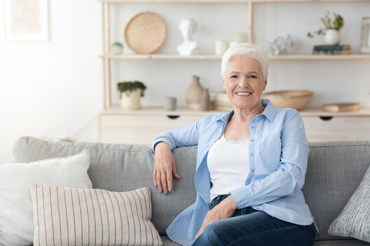 Relaxed Elderly Woman Posing On Couch Im Cozy Home Interior