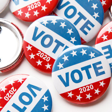 Close up of voting pins for 2020 US elections on white
