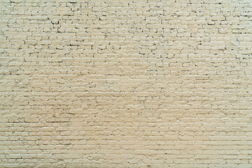 Beige brick wall. Loft interior design. Light yellow paint of the facade.
