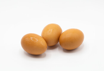 Three brown chicken's eggs isolated on white background.