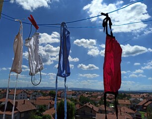 colorful covid-19 masks hanging after being washed