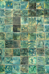 Green decorative tiles. The wall of the old house.