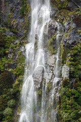 Fototapeta na wymiar Water falls on Milford Sound - New Zealand. Fiordland National Park.