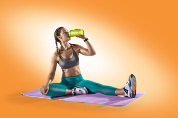 Young girl drinking water of bottle after training. Fitness and healthy lifestyle concept.