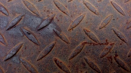 Details of a rusty ancient steel plate with some wet parts