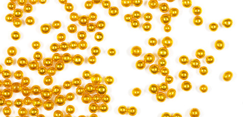 Small balls of gold on a white background.