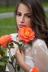 beautiful brunette with orange rose - 367527510