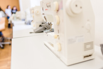 Seamstress crocheting wool close-up. Handmade and hobbies. A knitter is sewing a yellow knitted toy.