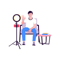 Young male blogger recording video at home