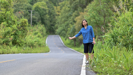 Tourist woman standing hitchhiker for travel.