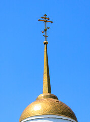 Orthodox cross on the temple against the blue sky.