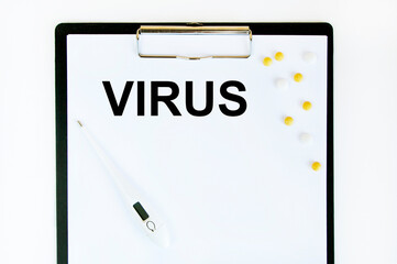 The inscription on the tablet with a sheet of VIRUS paper attached, a tablet and a thermometer next to it.