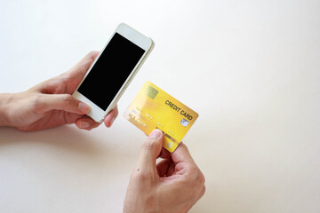 Online payment,Man's hands holding a credit card and using smart phone for online shopping