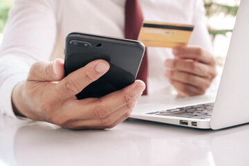 Online payment,Man's hands holding a smartphone and using credit card for online shopping