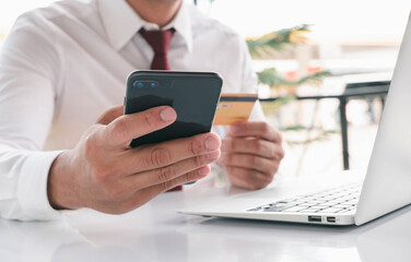 Online payment,Man's hands holding a smartphone and using credit card for online shopping